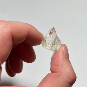 clear apophyllite crystal in hand for size